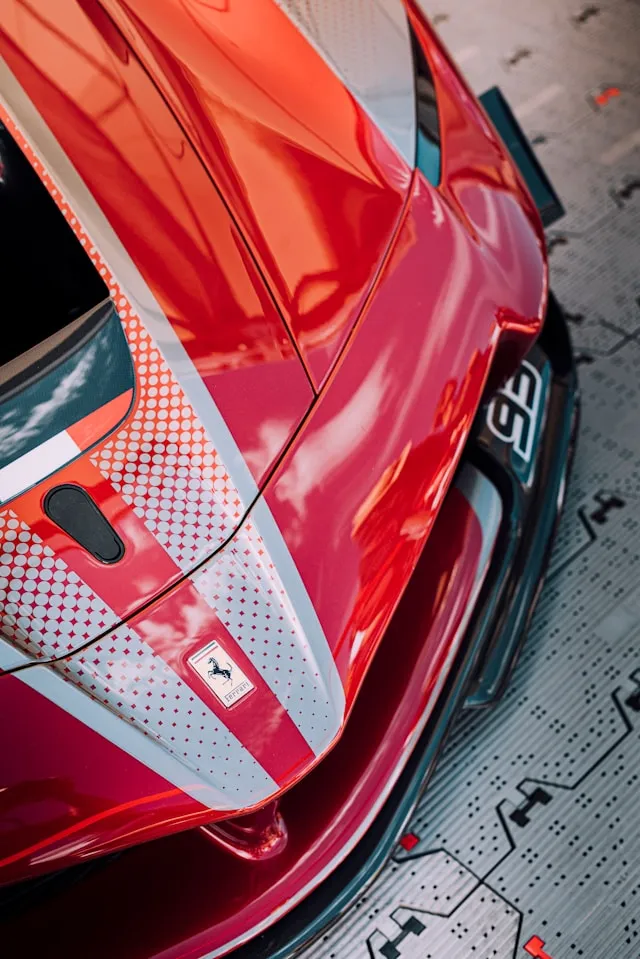 Red supercar with white halftone dot livery stripes on the hood