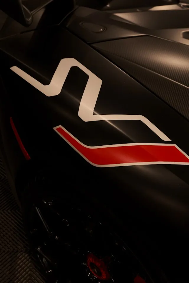 Matte black supercar with white and red lightning swoosh side graphic