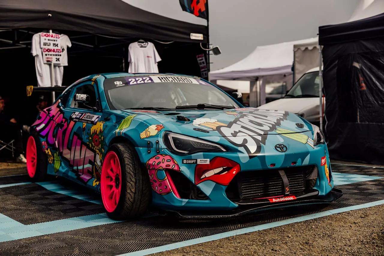 Blue drift car with pop-art donut and ice-cream vinyl wrap and pink wheels